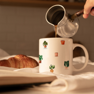 White mug with small potted plant design